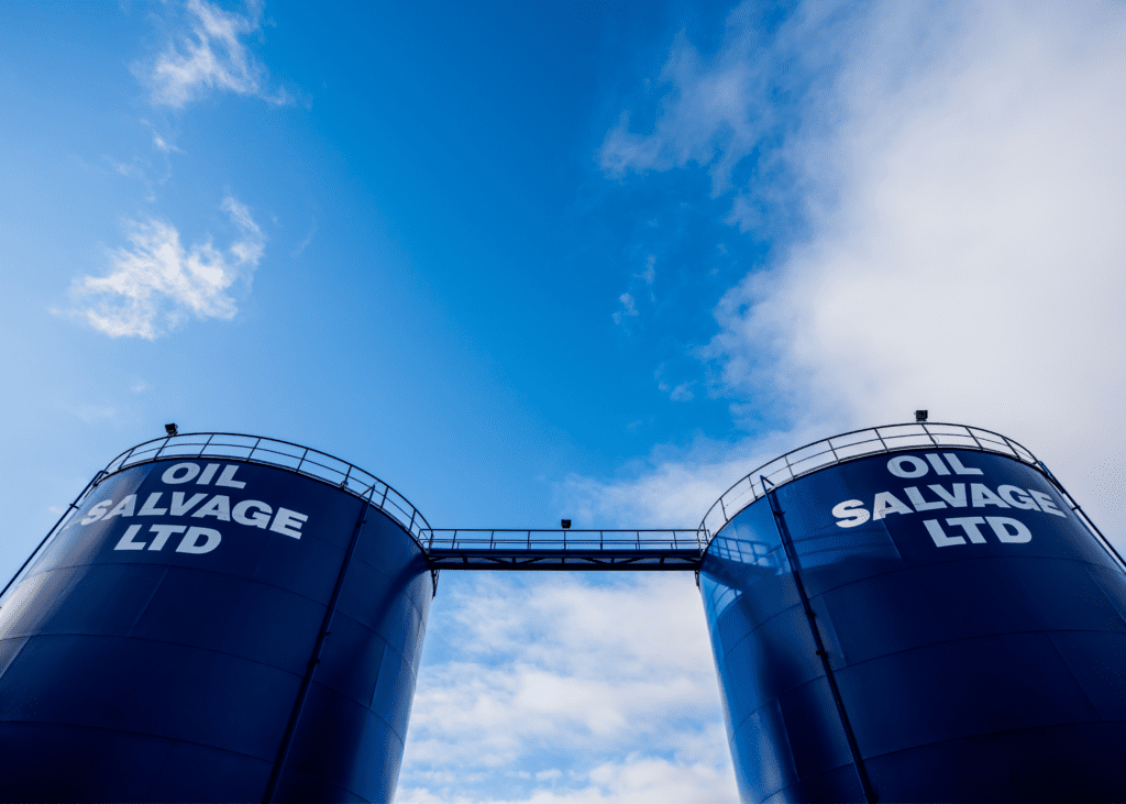 the Oil Salvage oil drums against a blue sky